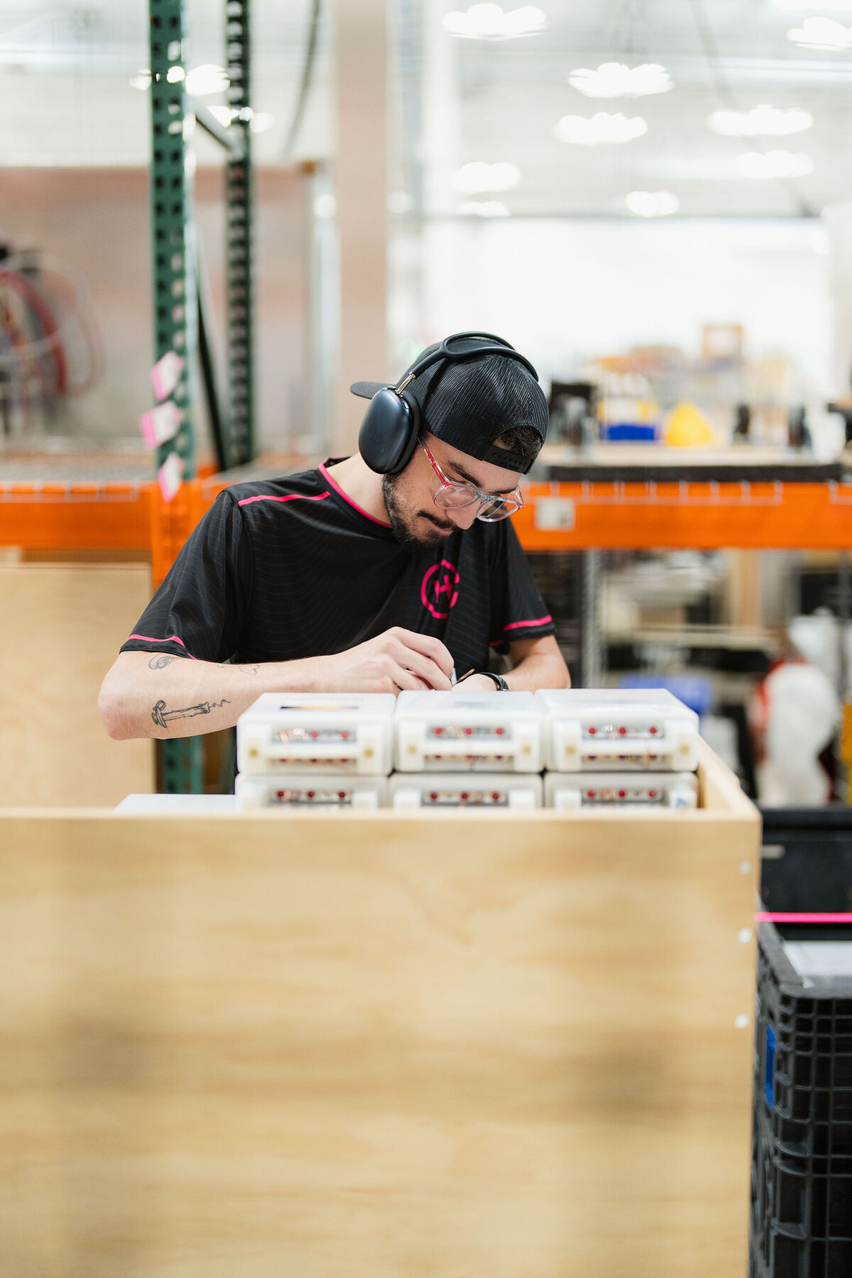 A technician assembles precision components on an Everett production floor